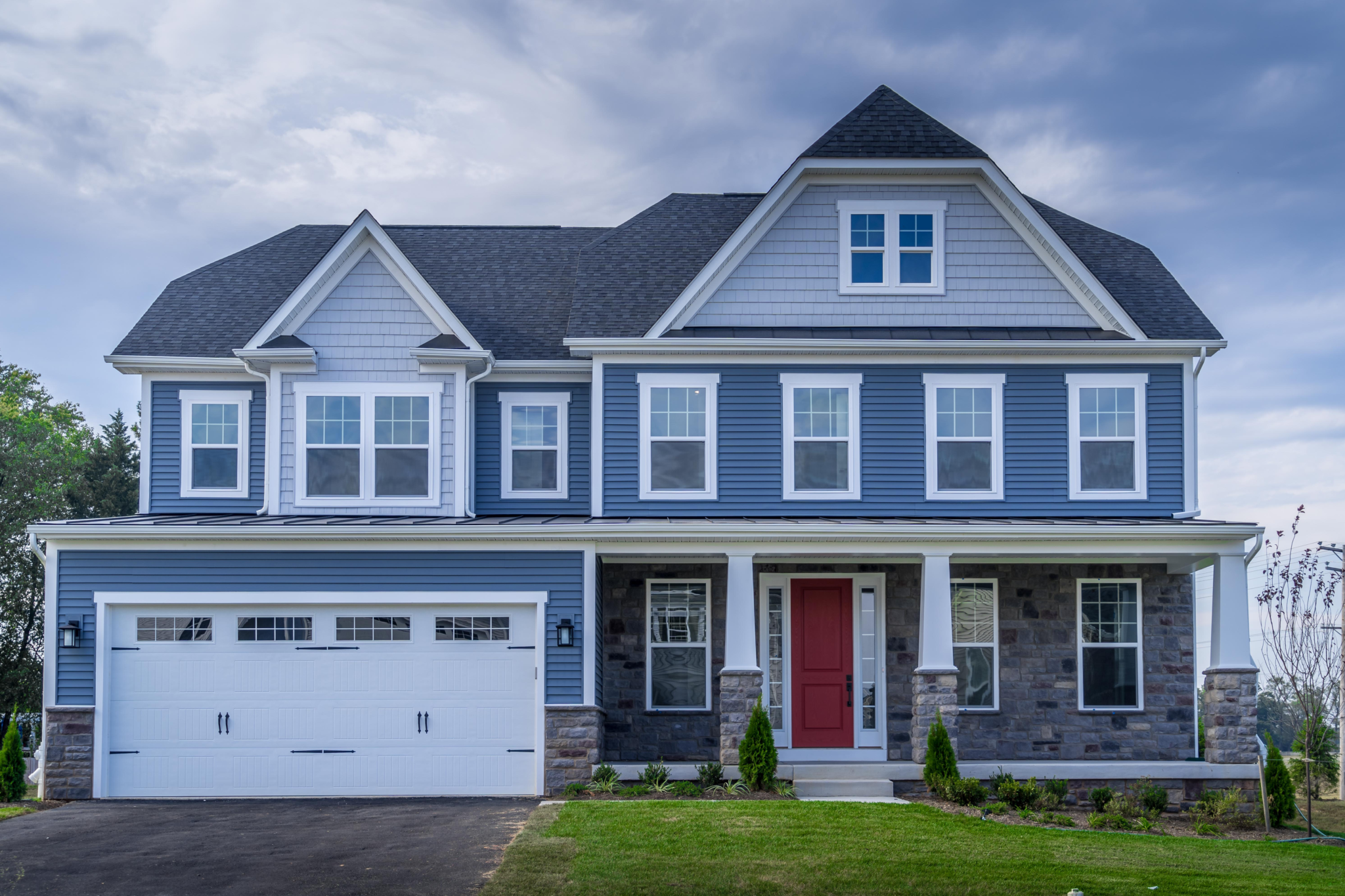 Blue vinyl siding replacement expertly completed by a trusted roofing company in St. Charles, IL.